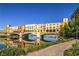 Picturesque lake view showcasing colorful buildings, a bridge, and clear reflections on the tranquil water at 47 Strada Principale, Henderson, NV 89011