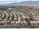 Aerial view of the residential neighborhood with well-maintained homes, desert landscaping, community pools, and mountain views at 5115 Morning Splash Ave, Las Vegas, NV 89131