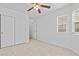 Bright bedroom with neutral carpet, closet, and windows for natural light at 5115 Morning Splash Ave, Las Vegas, NV 89131