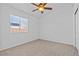 Neutral bedroom with carpet, ceiling fan and a window for natural light at 5115 Morning Splash Ave, Las Vegas, NV 89131