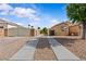 Long driveway leading up to a single-story home with desert landscaping and gated RV parking at 5115 Morning Splash Ave, Las Vegas, NV 89131