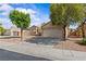 Charming home with a well-maintained exterior, two-car garage, desert landscaping, and mature trees at 5115 Morning Splash Ave, Las Vegas, NV 89131