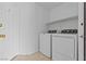 Bright laundry room features a new washer and dryer, plus shelving, and access door at 5115 Morning Splash Ave, Las Vegas, NV 89131