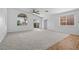 Spacious living room with vaulted ceilings, ceiling fan, and carpet flooring at 5115 Morning Splash Ave, Las Vegas, NV 89131