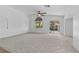 Spacious living room with vaulted ceilings, ceiling fan, and carpet flooring at 5115 Morning Splash Ave, Las Vegas, NV 89131