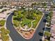 Aerial view of neighborhood green space featuring walking paths, lush trees, and Gathering park areas at 5115 Morning Splash Ave, Las Vegas, NV 89131