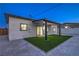 Backyard with a covered patio, well-maintained artificial grass, and rock landscaping for low maintenance at 5200 Blanton Dr, Las Vegas, NV 89122