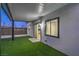 The backyard features a covered patio, sliding glass doors, and an artificial grass lawn at 5200 Blanton Dr, Las Vegas, NV 89122