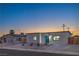 Charming single-story home featuring a modern exterior, desert landscaping, and a freshly paved driveway at 5200 Blanton Dr, Las Vegas, NV 89122