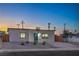 Charming single-story home featuring a modern exterior, desert landscaping, and a freshly paved driveway at 5200 Blanton Dr, Las Vegas, NV 89122