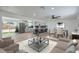 Open-concept living area with a modern kitchen, dining space, and a sliding glass door to the backyard at 5200 Blanton Dr, Las Vegas, NV 89122