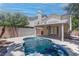 Private backyard featuring a pool, covered patio, and lush landscaping for outdoor enjoyment at 5811 Pack Trl, Las Vegas, NV 89118