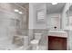 Updated bathroom featuring a glass enclosed shower, single sink vanity, and neutral tiling at 5811 Pack Trl, Las Vegas, NV 89118