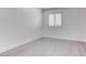Minimalist bedroom with bright white walls and gray wood-look flooring at 5811 Pack Trl, Las Vegas, NV 89118