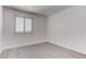 Minimalist bedroom with bright white walls and gray wood-look flooring at 5811 Pack Trl, Las Vegas, NV 89118