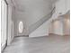 Bright entryway with a soaring ceiling, modern staircase, and gray wood-look flooring at 5811 Pack Trl, Las Vegas, NV 89118