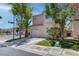 Charming two-story home with a well-maintained lawn, mature trees, and a convenient attached garage at 5811 Pack Trl, Las Vegas, NV 89118