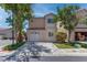 Two story home with lawn, two car garage, and desert landscaping at 5811 Pack Trl, Las Vegas, NV 89118