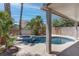 Relaxing outdoor pool area features beautiful tile work, mature plants, and a covered patio at 5811 Pack Trl, Las Vegas, NV 89118