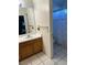 Bathroom featuring a vanity with storage, a mirror, tiled floors, and a shower with a decorative shower curtain at 6208 Mandarin Dr, Las Vegas, NV 89108