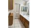 Bathroom with wood cabinets, a white countertop, and tiled flooring at 6208 Mandarin Dr, Las Vegas, NV 89108