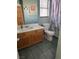 Neutral bathroom featuring a vanity with storage, a mirror, tile floors, and a shower with a patterned shower curtain at 6208 Mandarin Dr, Las Vegas, NV 89108