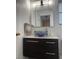 Bathroom featuring a modern vanity with a vessel sink and decorative mirror at 6208 Mandarin Dr, Las Vegas, NV 89108