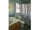 Bright bathroom features a single sink, floral shower curtain, and a window with blinds at 6208 Mandarin Dr, Las Vegas, NV 89108