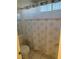 Bathroom with white tiles, tub-shower combo, and decorative shower curtain at 6208 Mandarin Dr, Las Vegas, NV 89108