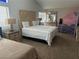 Bright bedroom with a unique headboard, neutral carpeting, and a lofted bed, creating a cozy and inviting space at 6208 Mandarin Dr, Las Vegas, NV 89108