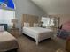 Bright bedroom with a unique headboard, neutral carpeting, and a lofted bed, creating a cozy and inviting space at 6208 Mandarin Dr, Las Vegas, NV 89108