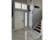 Welcoming entryway with marble tile flooring, natural light, and stairs leading to the upper level, offering style and functionality at 6208 Mandarin Dr, Las Vegas, NV 89108