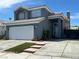 Charming two-story home featuring a well-manicured lawn, a two-car garage, and a welcoming entrance, providing curb appeal at 6208 Mandarin Dr, Las Vegas, NV 89108