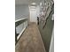Hallway with neutral carpet, a decorative mirror on the wall, and a glass railing overlooking downstairs at 6208 Mandarin Dr, Las Vegas, NV 89108
