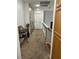 Hallway with neutral carpet, gray walls, unique wall art and natural light, creating an inviting transition space at 6208 Mandarin Dr, Las Vegas, NV 89108