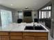 Stylish kitchen with marble countertops, a double sink, and view to the living room at 6208 Mandarin Dr, Las Vegas, NV 89108