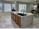 Modern kitchen island with granite counters and open concept floor plan to living area at 6208 Mandarin Dr, Las Vegas, NV 89108