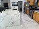 Bright kitchen featuring a white marble island, stainless steel appliances, and light wood cabinetry at 6208 Mandarin Dr, Las Vegas, NV 89108