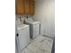 Laundry room with a side-by-side washer and dryer, and overhead cabinets at 6208 Mandarin Dr, Las Vegas, NV 89108