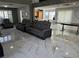 Spacious living room featuring dual sofas, large windows, and sleek marble flooring at 6208 Mandarin Dr, Las Vegas, NV 89108