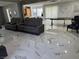 Open concept living room with comfortable seating, clock, and large windows at 6208 Mandarin Dr, Las Vegas, NV 89108