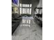 Open-concept living area with tile floors, modern furniture, and large windows at 6208 Mandarin Dr, Las Vegas, NV 89108