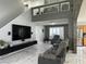Modern living room features tile floors, neutral decor, and tall ceilings, creating an open and airy space at 6208 Mandarin Dr, Las Vegas, NV 89108