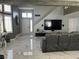 Open living room showcasing a television, marble flooring, and neutral decor at 6208 Mandarin Dr, Las Vegas, NV 89108