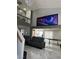 Living room with a modern gray sofa, large screen TV, and bright, open space at 6208 Mandarin Dr, Las Vegas, NV 89108
