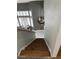 View from the top of the staircase featuring wooden steps and white risers leading to the main level at 6208 Mandarin Dr, Las Vegas, NV 89108