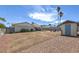Spacious backyard with palm trees, a shed, patio, and seating area, perfect for outdoor living at 6920 Singing Dunes Ln, Las Vegas, NV 89145