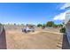 View of the backyard with a seating area, garden shed, and privacy fence at 6920 Singing Dunes Ln, Las Vegas, NV 89145