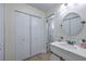 Bathroom view with vanity, patterned closet, and decorated tile flooring at 6920 Singing Dunes Ln, Las Vegas, NV 89145