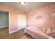 Pink bedroom with colorful wall decals and a closet with sliding doors at 6920 Singing Dunes Ln, Las Vegas, NV 89145